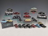 a lot of toy cars on display on a glass shelf