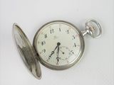 a pocket watch that is sitting on a table