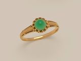 a gold ring with a green jade stone in the center