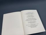 an open book with a poem on it sitting on a table
