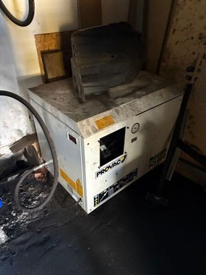 a dirty oven sitting in the corner of a room