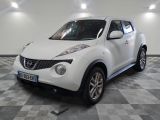 a picture of a white nissan juke suv parked in a garage