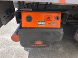 the back end of a truck with a small orange device on it