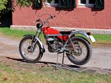 a red and white motorcycle parked on the side of the road