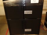a stack of black boxes sitting on a pallet in a warehouse
