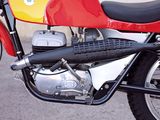 a red and yellow motorcycle parked on the side of the road