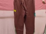 a pair of pants hanging on a rack in front of a bed