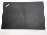 a black mouse pad on a table with a white background