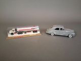 two toy cars that are sitting next to each other