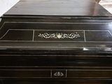 a black table with a black top and a gold decoration on top of it