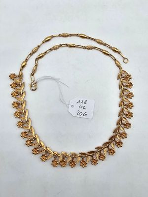 a gold plated necklace with leaves and leaves on it