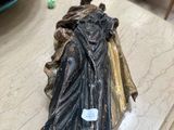 a statue of a woman sitting on top of a table