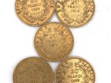 five different types of gold coins sitting on top of a white surface