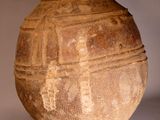 a large brown vase sitting on a white surface