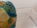a glass turtle sitting on top of a glass bowl