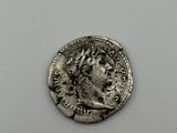 a silver coin with an image of a man on it