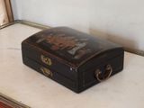 a small black suitcase sitting on top of a table