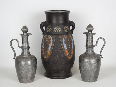 trois vases en argent et deux vases en argent posés sur une surface blanche