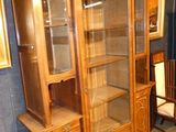 a wooden cabinet with a glass door in a room