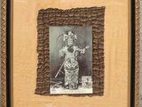 an old photo of a woman holding a cat in a frame
