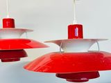 two red and white lamps hanging from the ceiling