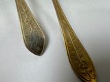 two spoons and a fork sitting on a table
