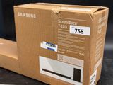 a cardboard box with a picture of a soundbar on it