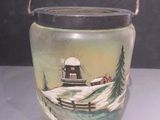 a glass jar with a picture of a boat on it