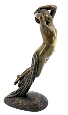 bronze statue of a woman holding a bowl on a rock