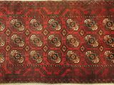 a red and black rug with a design on it