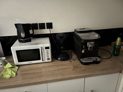 a microwave and a coffee maker on a kitchen counter