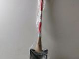 a plastic shovel with a wooden handle on a white surface