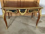 a wooden table with a black and gold design on it
