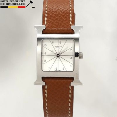 an image of a close up of a wrist watch with a brown strap