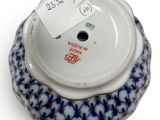 a small blue and white bowl with a tag on it