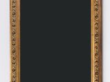 an antique gold frame with a black background on a white wall