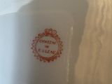 a white plate with a red design on it