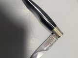 a knife that is laying on the table next to a knife