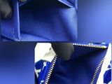 a close up of a blue purse with a zipper