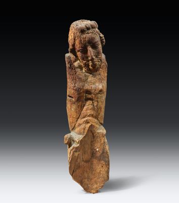 an ancient statue of a woman holding a baby