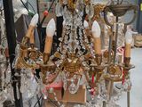 a chandelier that is sitting on a stand in a room