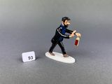 a figurine of a man holding a bottle of wine