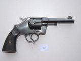 a close up of a revolver on a table with a tag on it