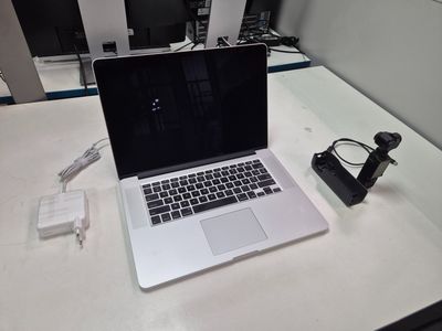 a laptop computer sitting on a desk with a charger