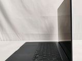 an open laptop computer sitting on top of a white surface