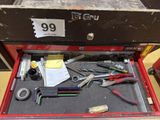 a red tool box with tools in it on a table
