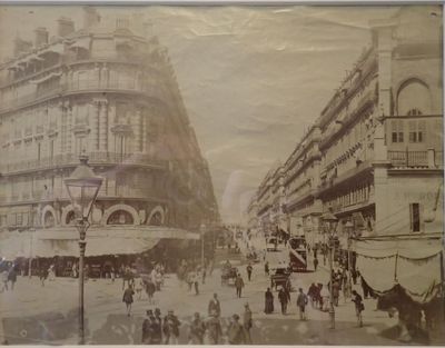 an old picture of a city street with people walking on it