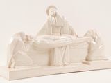 a figurine of a woman laying on a bed