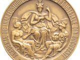 an image of a gold medal with a picture of a woman on a horse