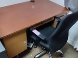 a desk with a chair and a computer on it